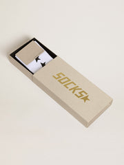 Worn white socks with contrasting black stars
