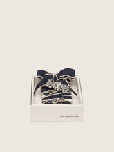 Skins denim blue laces embellished with beige trim and two charms