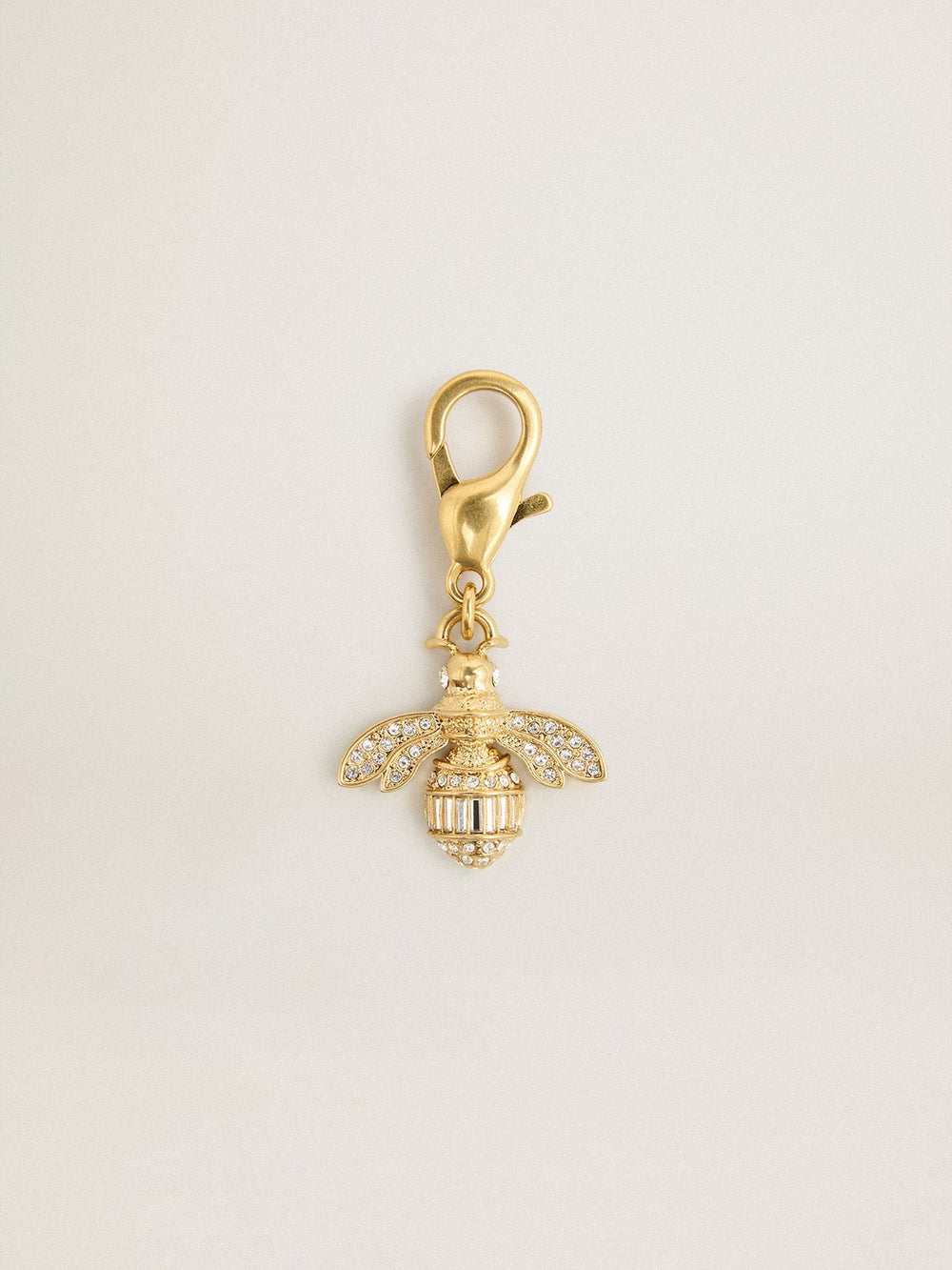 Bee-shaped charm in gold-colored brass with crystals