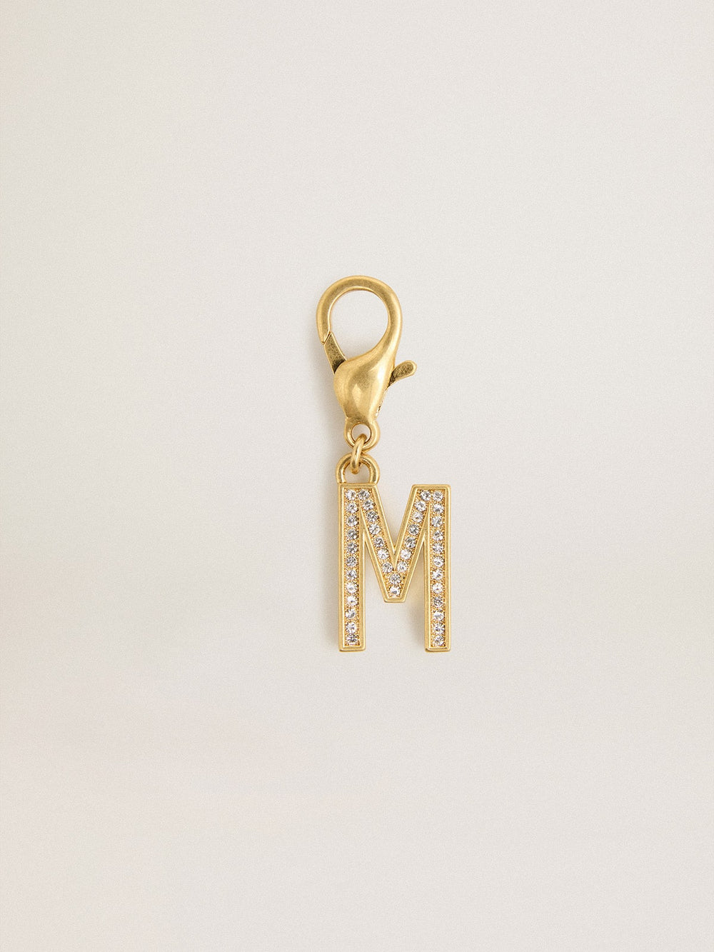 Letter M charm in gold-colored brass with crystals