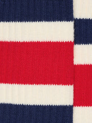 Worn-white socks with blue and red stripes