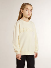 Girls’ cream-colored sweatshirt with patch writing