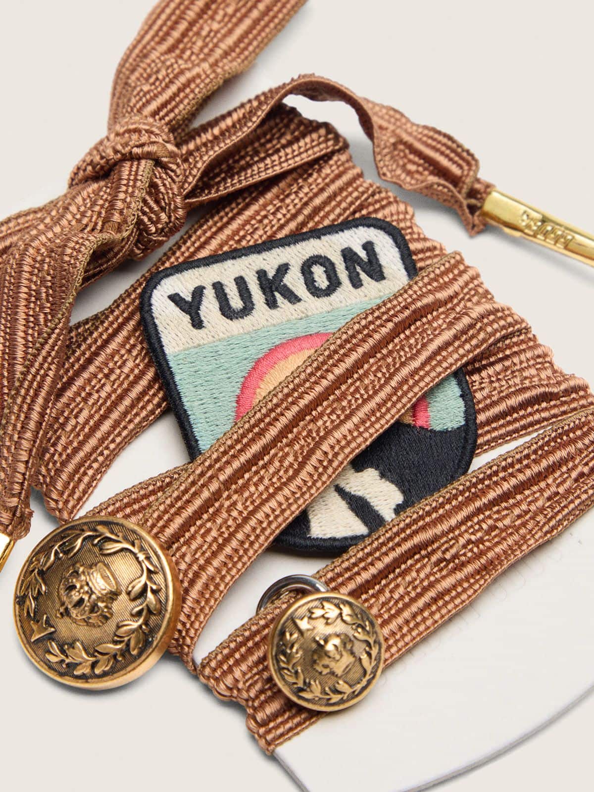 Skins burgundy and peach embroidered laces with patch and two charms