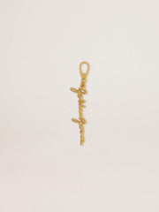 Gold-colored brass charm with Golden Goose signature