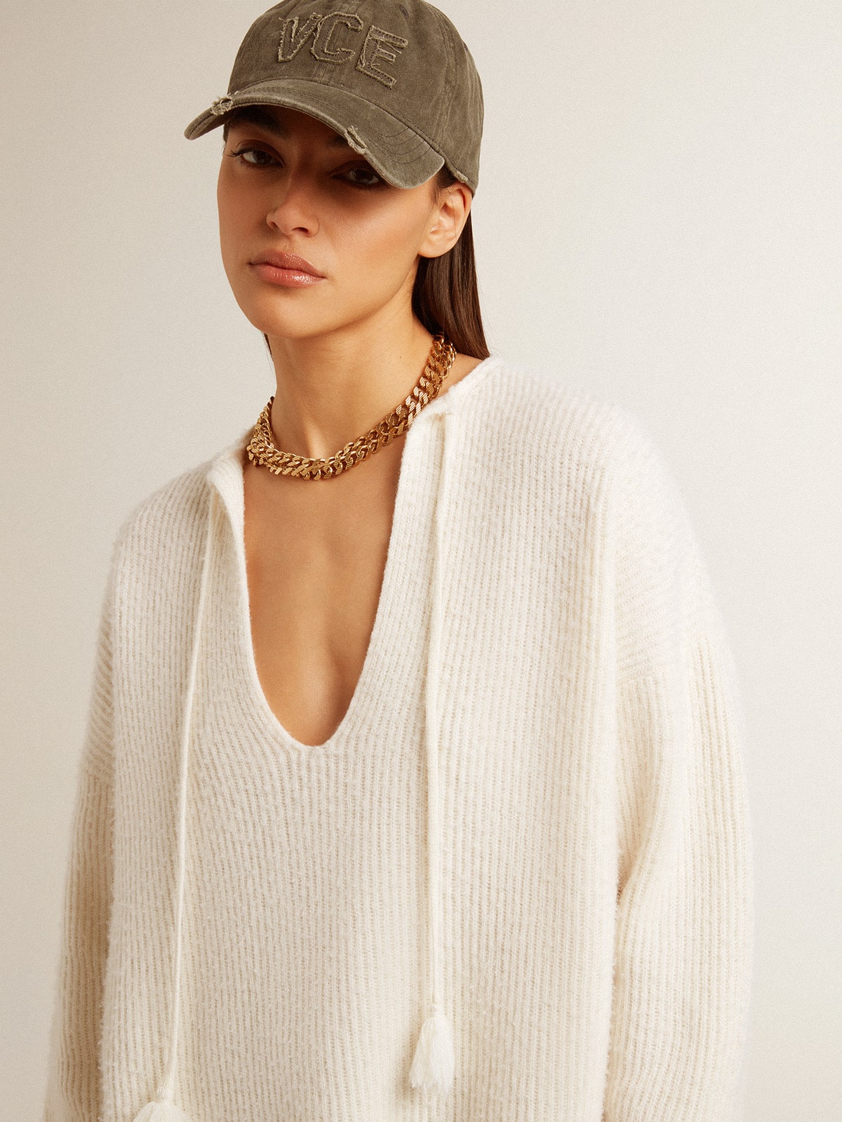 Ribbed wool sweater with V neck and drawstring with tassels