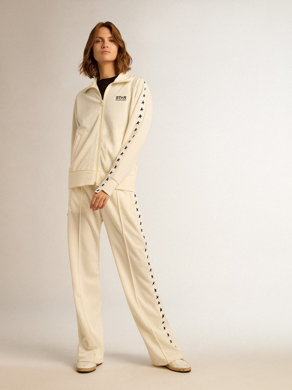 Women’s white zipped sweatshirt with white strip and black stars