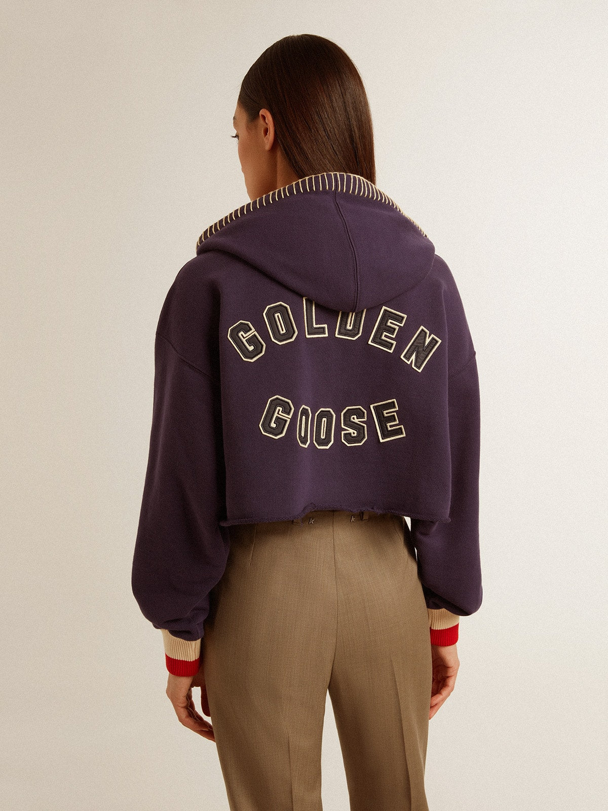 Dark blue cropped sweatshirt with zip fastening and embroidered hood