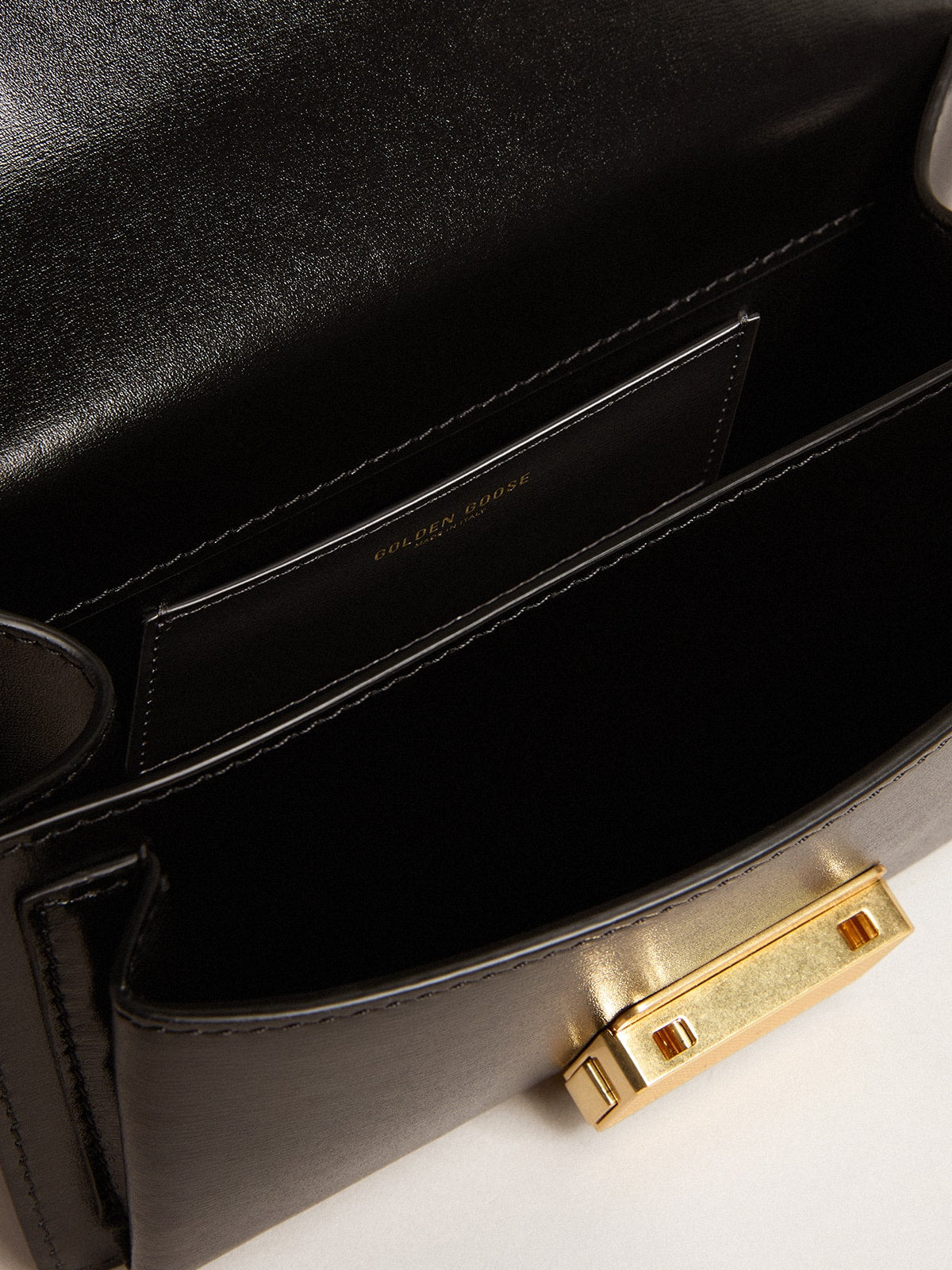 Small Venezia Bag in black boarded leather with silk scarf and charm