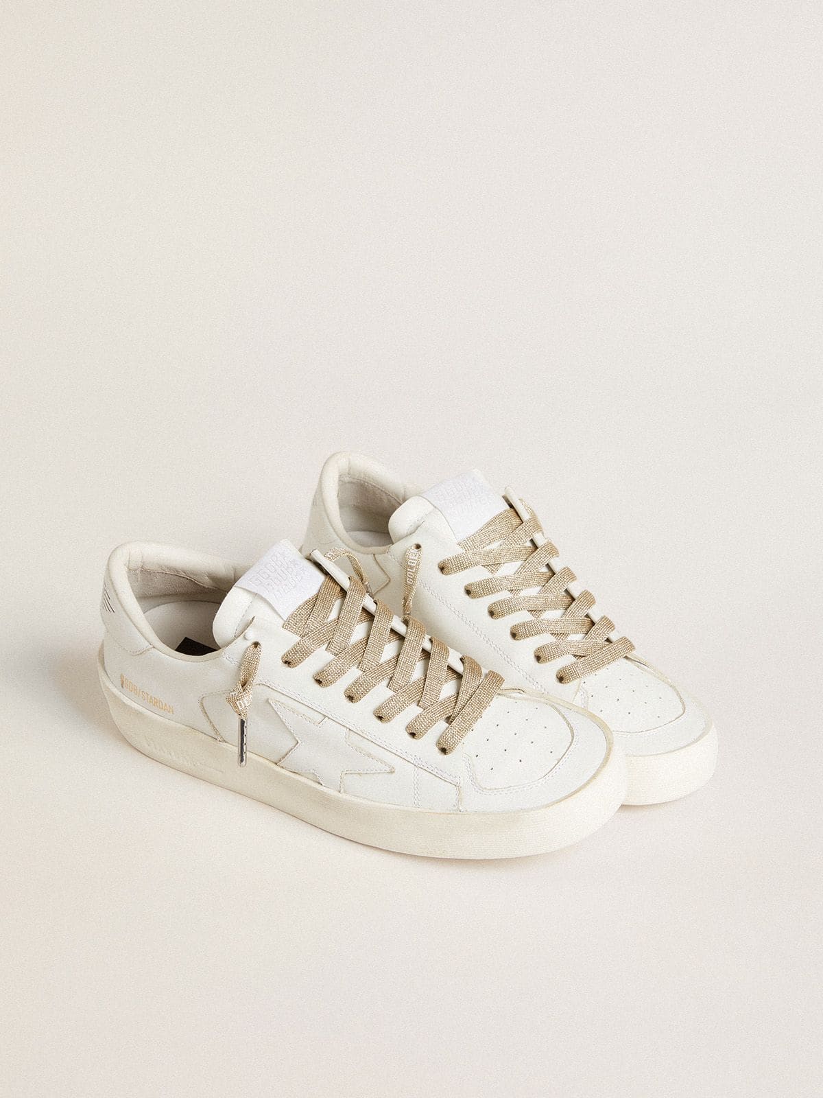 Gold-colored Lurex laces with contrasting white logo