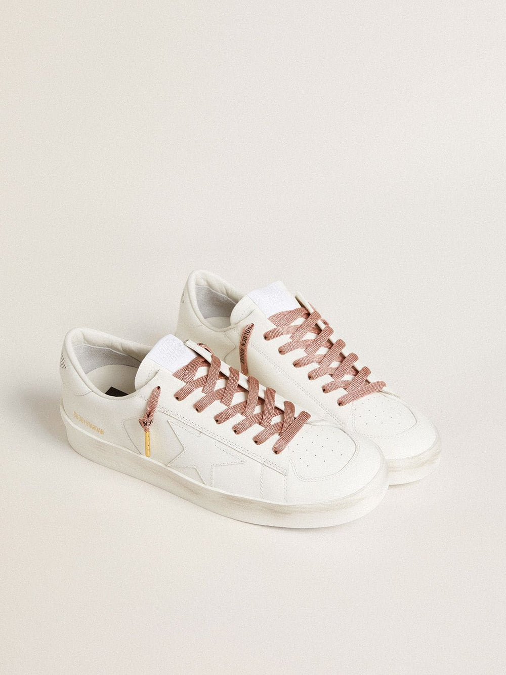 Salmon pink Lurex laces with contrasting black logo