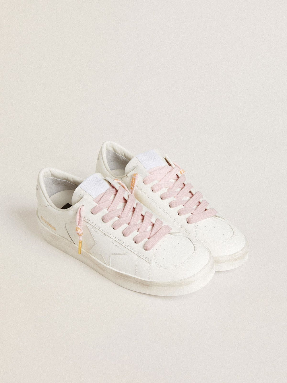 Pink cotton laces with contrasting gold-colored logo