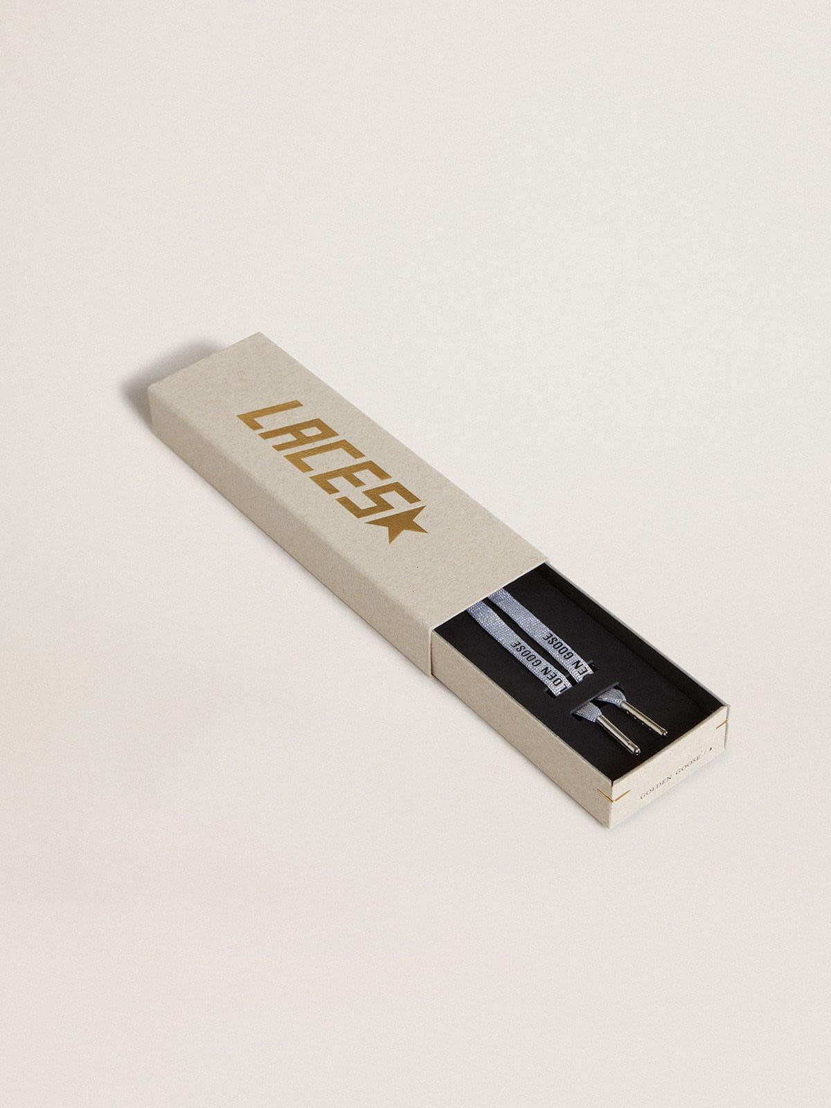 Silver-colored Lurex laces with contrasting black logo