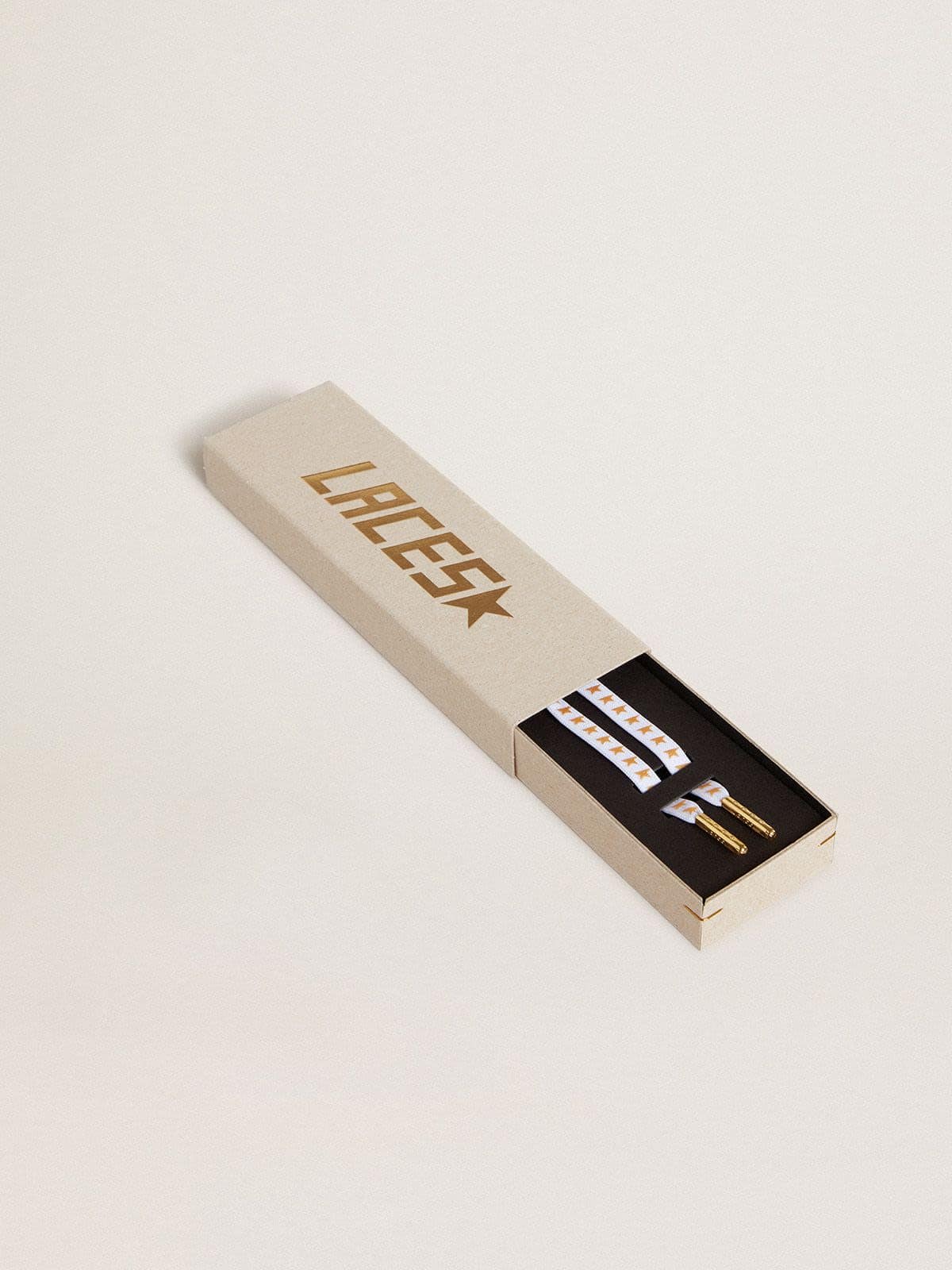 White cotton laces with contrasting gold stars