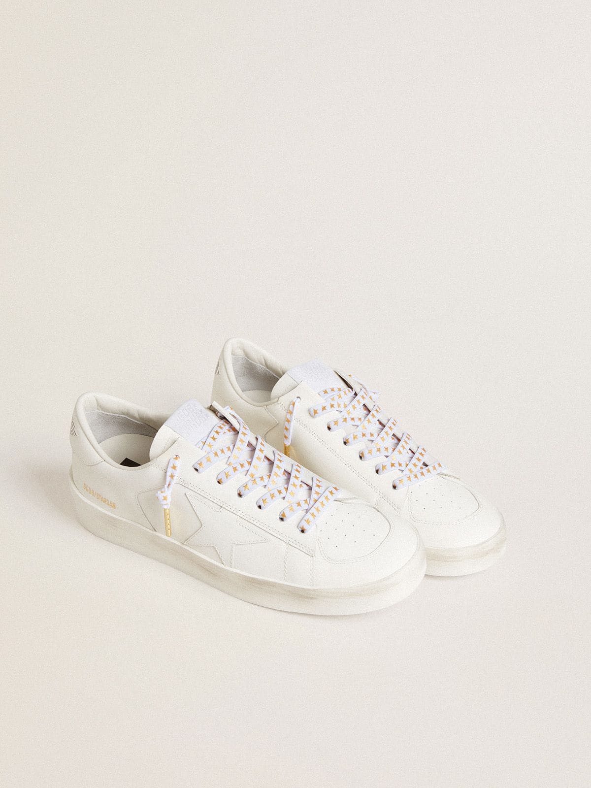 White cotton laces with contrasting gold stars