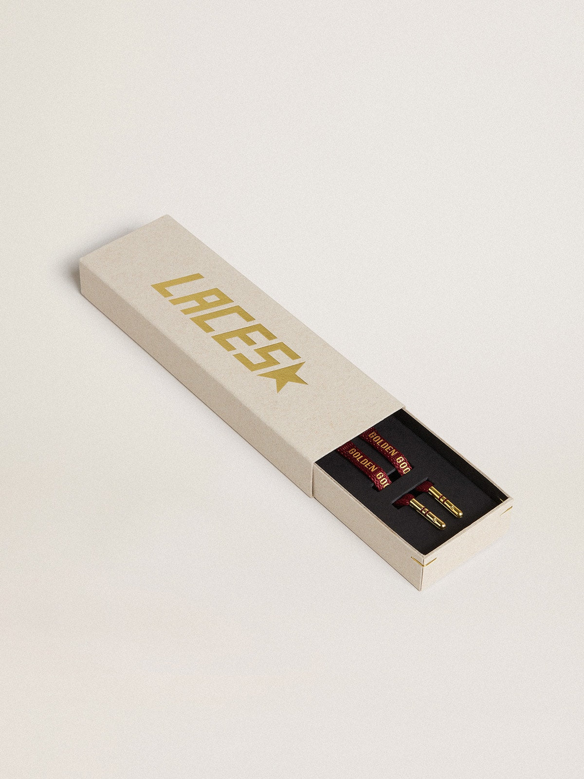 Burgundy cotton laces with contrasting gold-colored logo