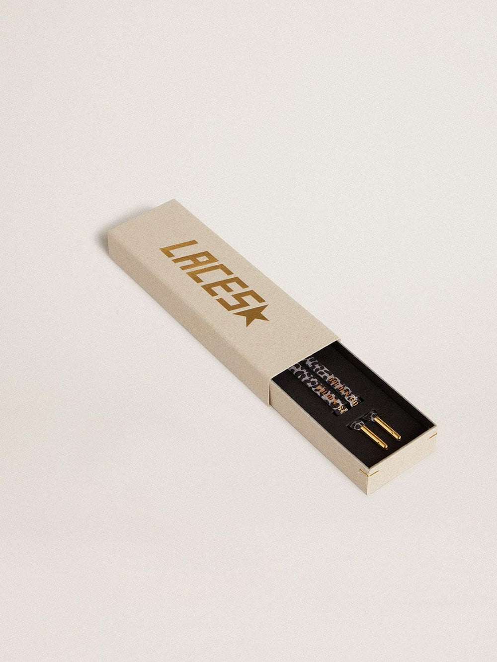 Gray and black animal-print laces with contrasting gold logo