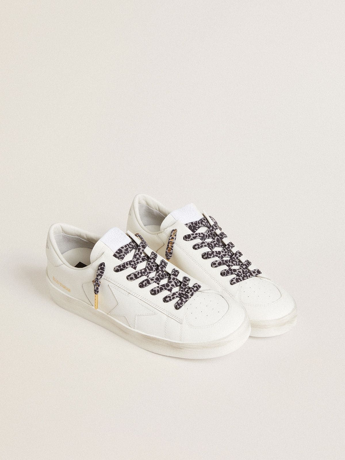 Gray and black animal-print laces with contrasting gold logo