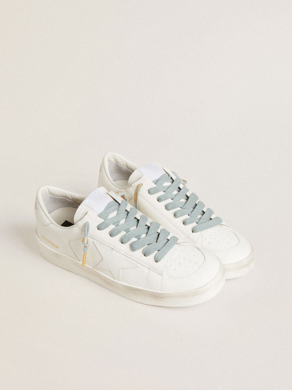 Light-blue cotton laces with contrasting gold-colored logo