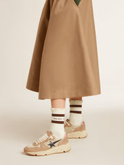 Worn-white socks with distressed details and brown stripes