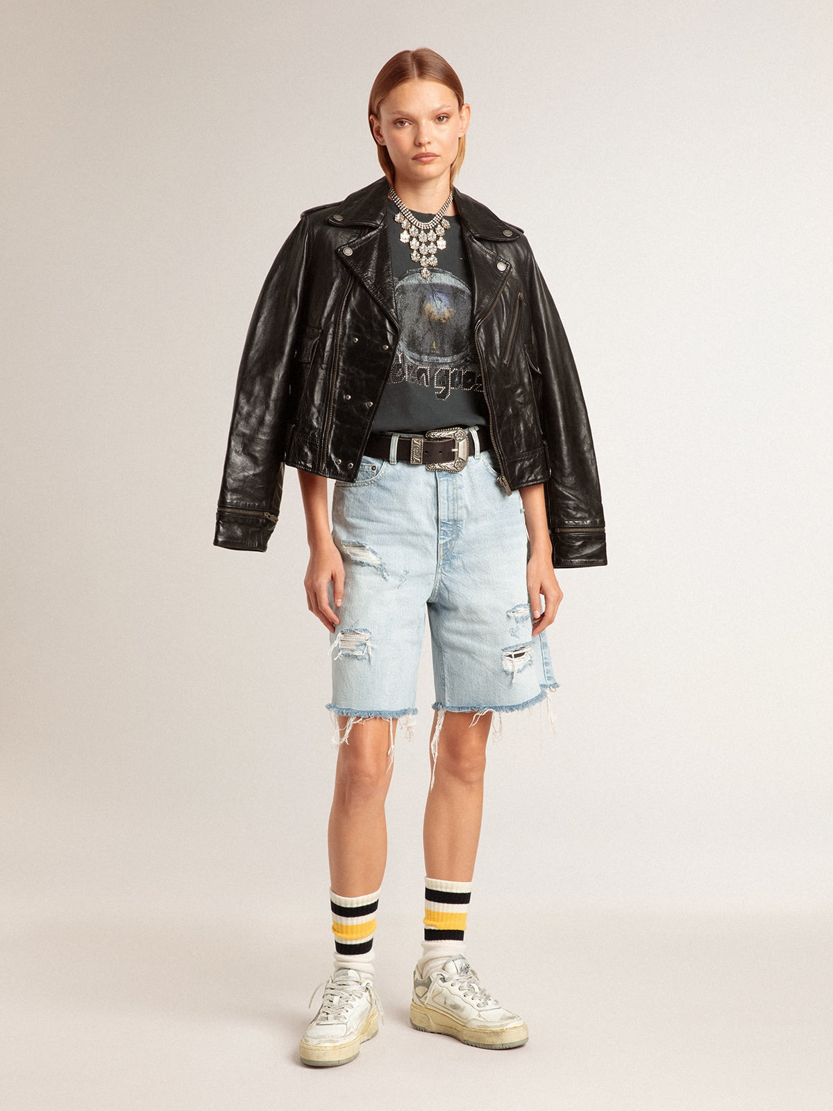 Worn-white socks with distressed details and black and yellow stripes