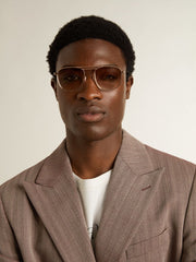 Aviator-style sunglasses with gold frame and beige lenses