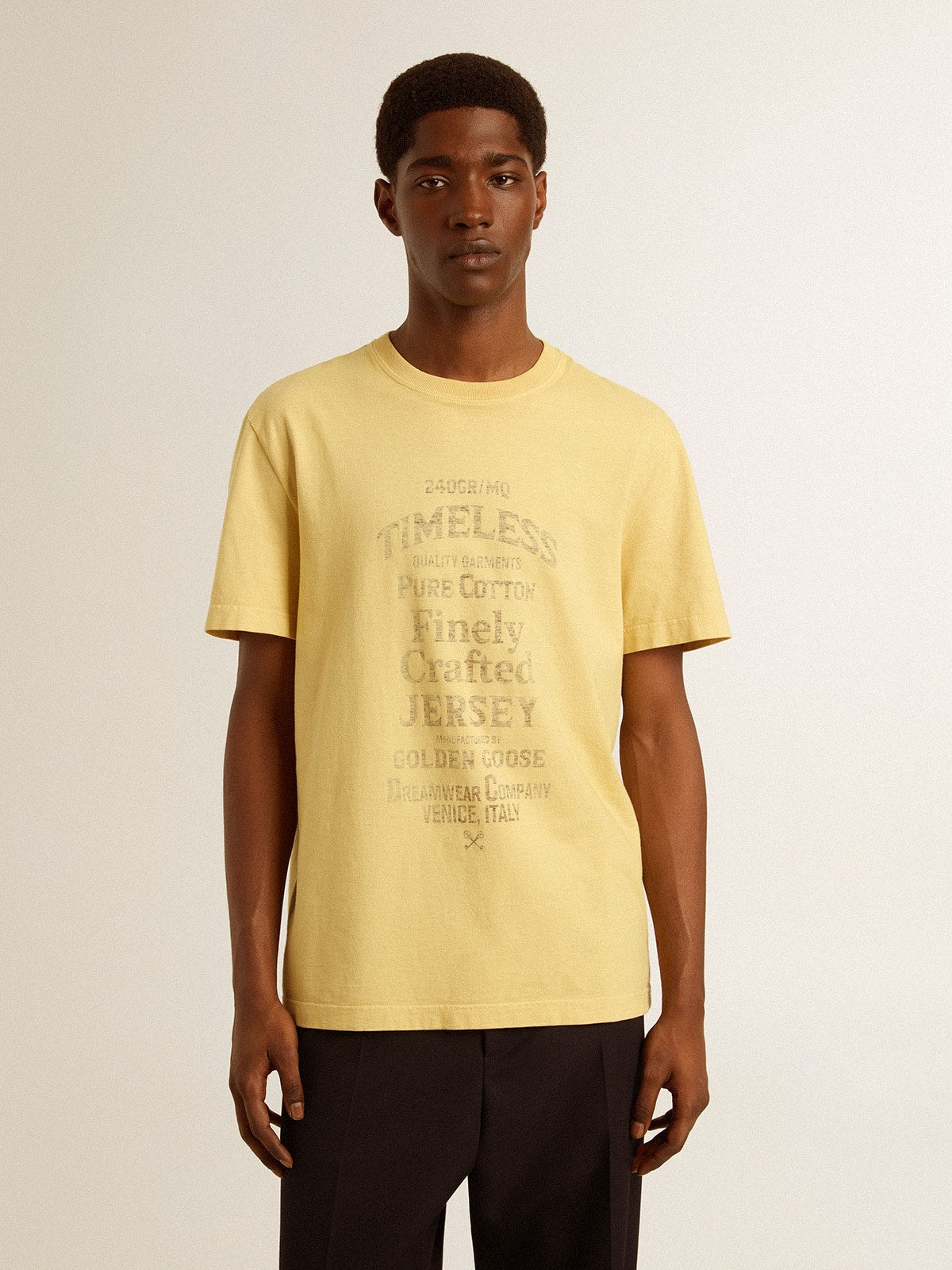 Men's cotton T-shirt in pale yellow with faded lettering