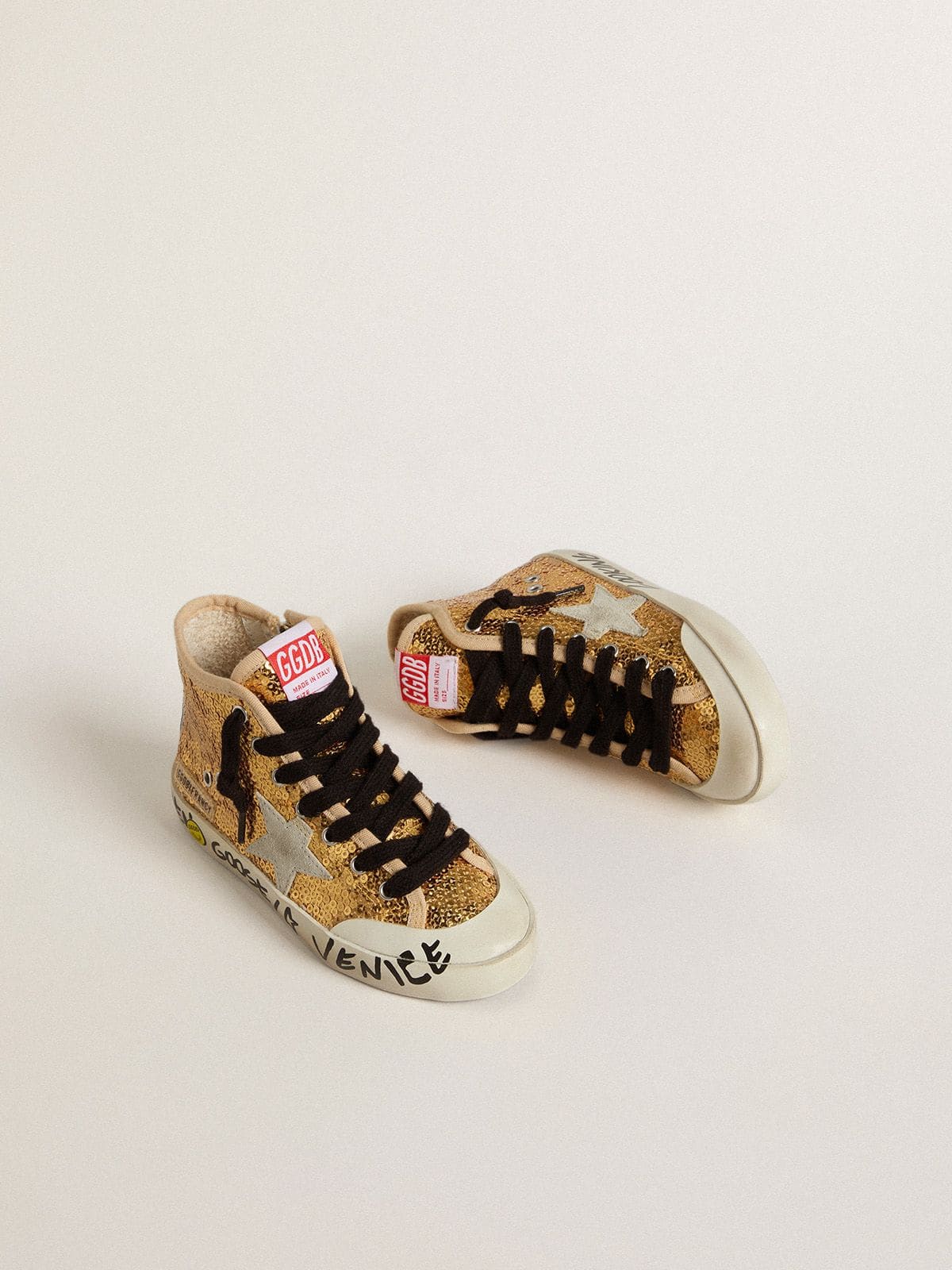 Young Francy Penstar in gold sequins with ice-gray suede star