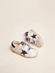 Old School Junior in white leather with blue suede star and heel tab